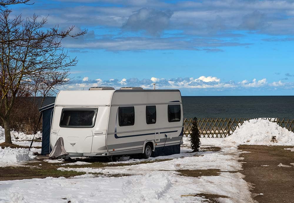 RV in snow by lake